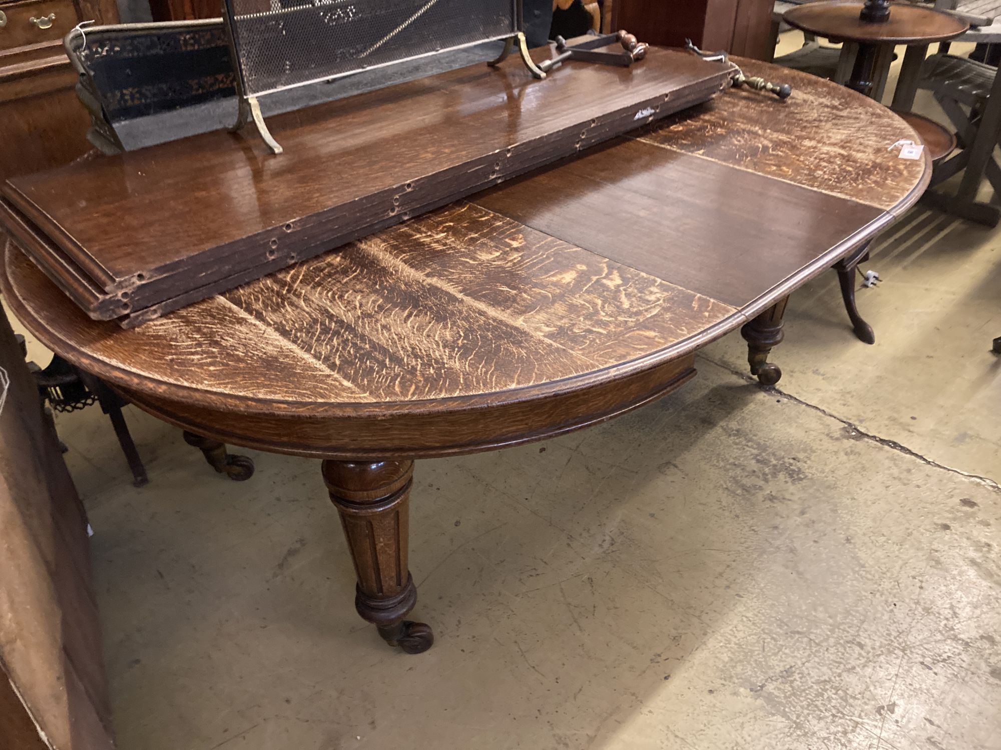 A Victorian oak extending dining table, length 320cm extended (five spare leaves), width 140cm, height 76cm